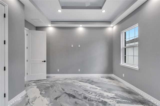 spare room featuring a tray ceiling