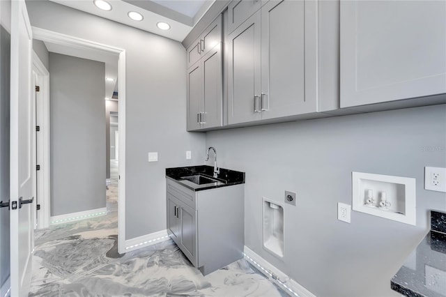 clothes washing area featuring cabinets, electric dryer hookup, sink, and light tile floors