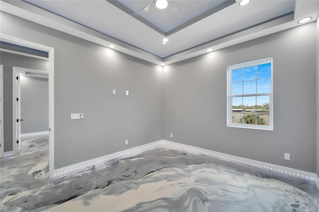 spare room featuring a raised ceiling