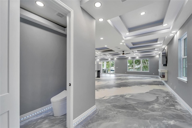 hallway featuring a tray ceiling