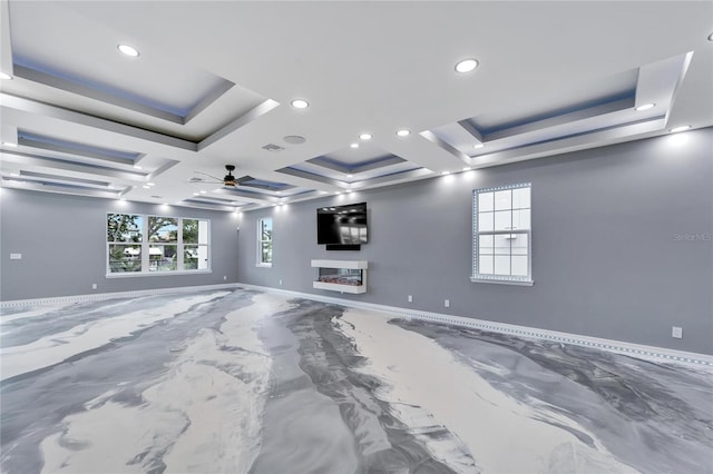 empty room featuring a raised ceiling, coffered ceiling, and ceiling fan