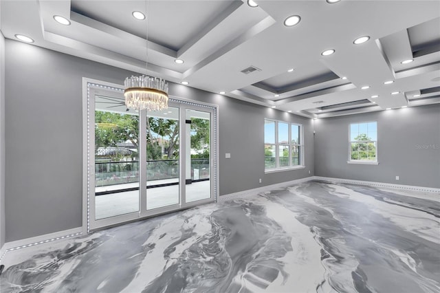 unfurnished room with coffered ceiling, a tray ceiling, and an inviting chandelier