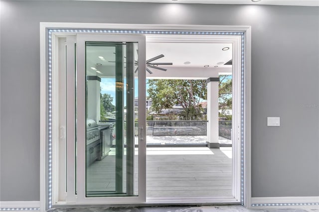 doorway featuring ceiling fan