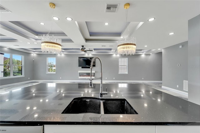 interior space with dark stone counters, decorative light fixtures, and a chandelier