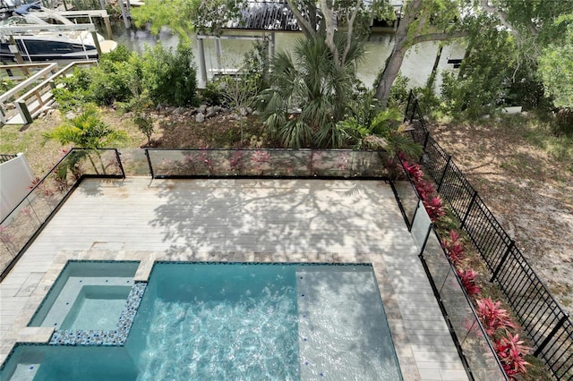 view of basketball court featuring a pool with connected hot tub and fence