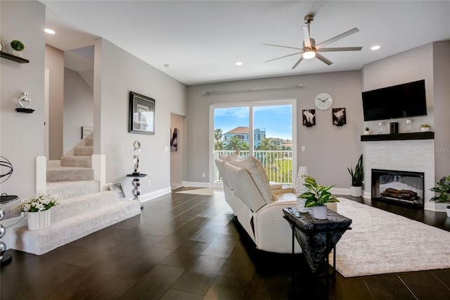 living room featuring dark hardwood / wood-style flooring and ceiling fan