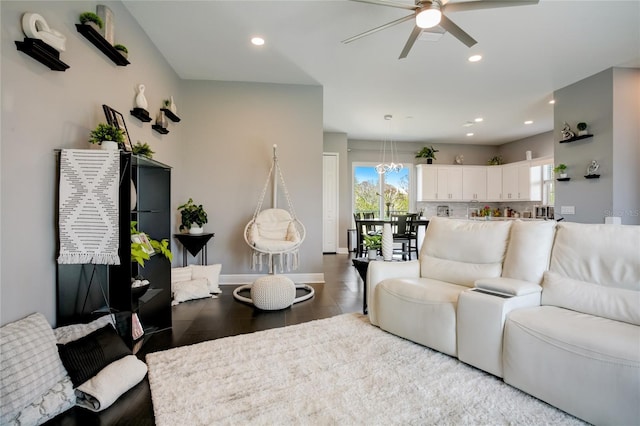 living room with ceiling fan with notable chandelier