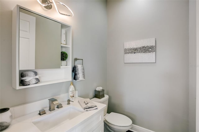 bathroom with toilet and vanity