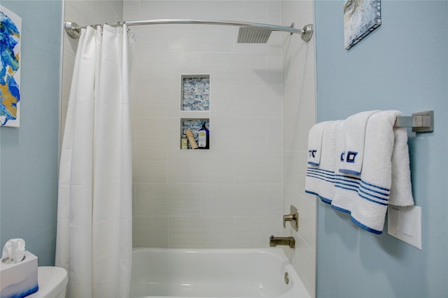 bathroom featuring shower / tub combo and toilet