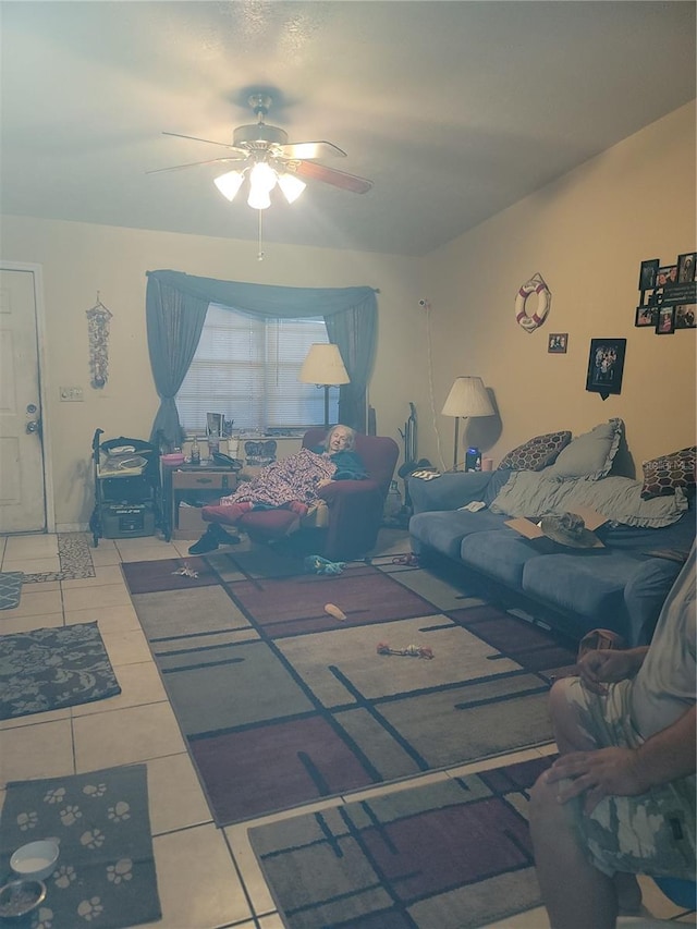 living room featuring light tile floors and ceiling fan