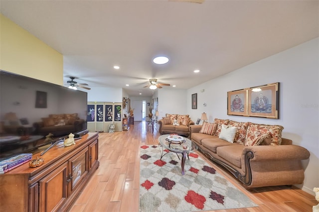 living room with light wood-type flooring and ceiling fan