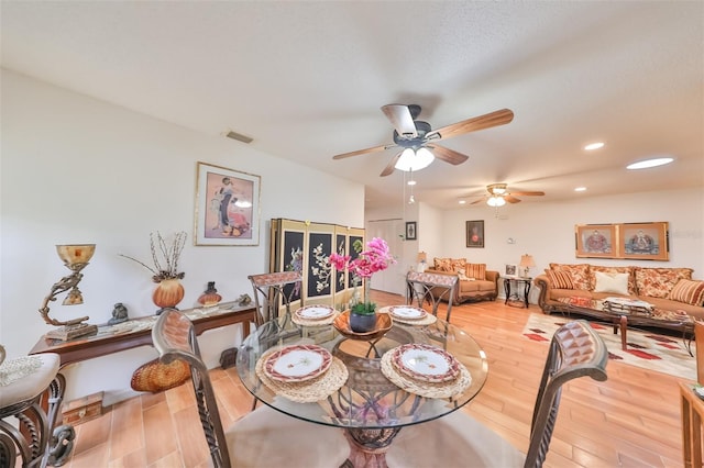 dining space with wood-type flooring and ceiling fan