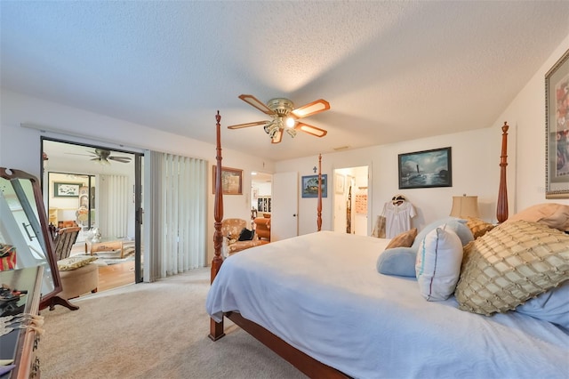 carpeted bedroom featuring ceiling fan, ensuite bathroom, and a textured ceiling