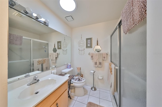 bathroom with tile patterned floors, a shower with door, vanity, and toilet