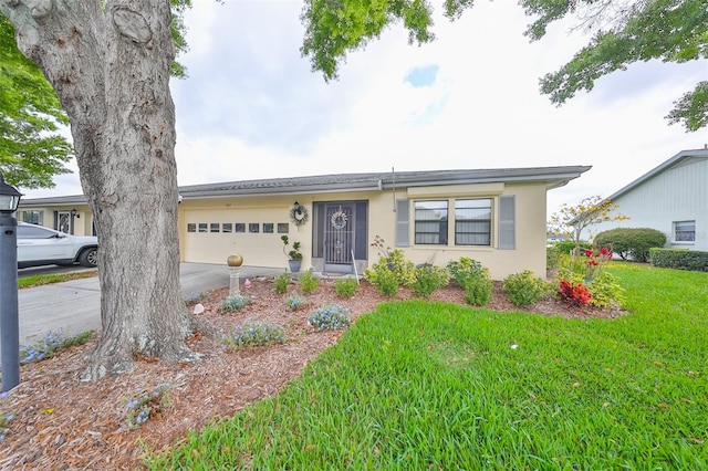 single story home with a front yard and a garage