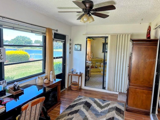 interior space featuring ceiling fan and a water view