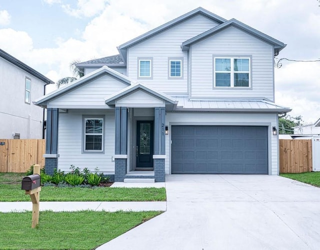 view of front of house featuring a garage and a front lawn