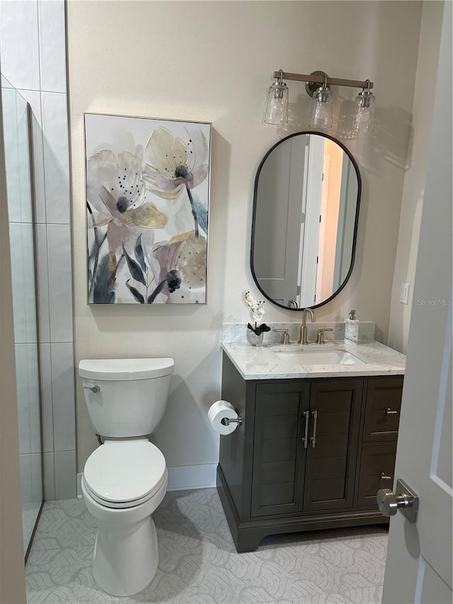 bathroom with tile patterned floors, vanity, and toilet