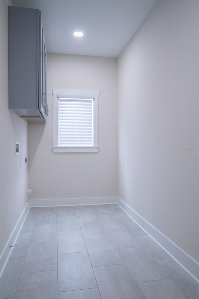 clothes washing area with electric dryer hookup, cabinets, and hookup for a washing machine