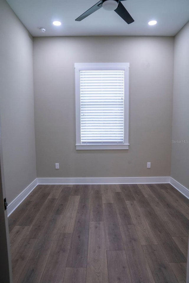 empty room featuring dark wood-type flooring and ceiling fan