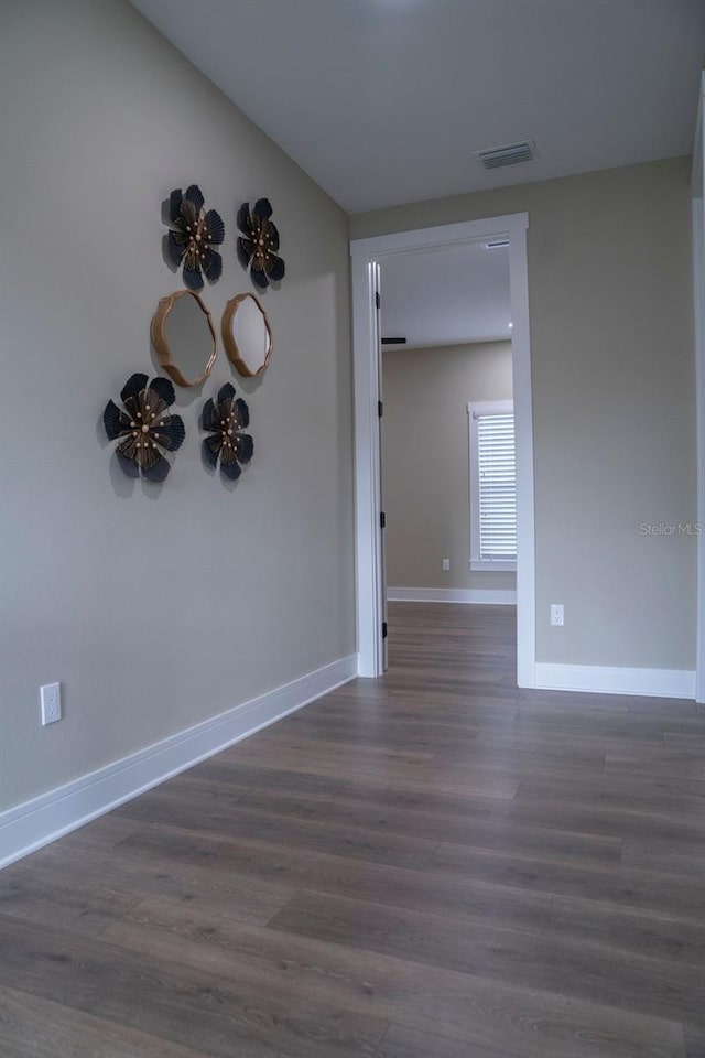 unfurnished room featuring dark hardwood / wood-style flooring