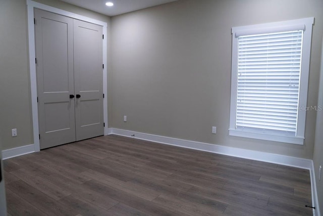 spare room with dark hardwood / wood-style floors