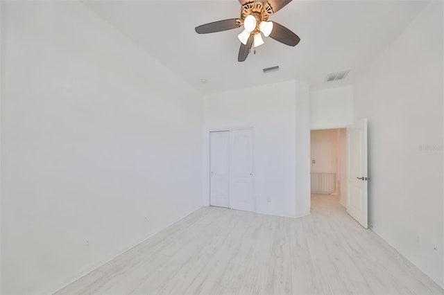 unfurnished bedroom featuring a closet, ceiling fan, and light hardwood / wood-style flooring