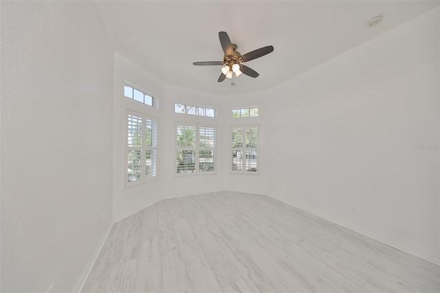 empty room with ceiling fan and hardwood / wood-style floors