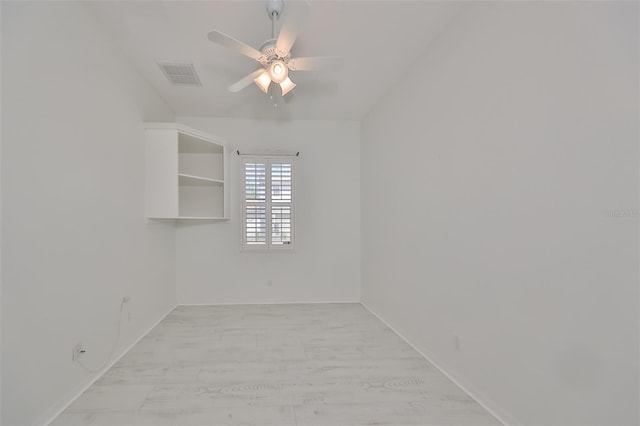 spare room featuring wood-type flooring and ceiling fan