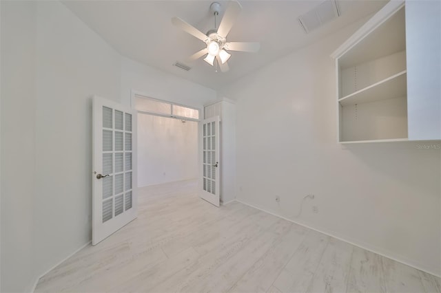 spare room featuring french doors, light hardwood / wood-style flooring, and ceiling fan