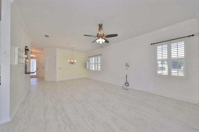 spare room with ceiling fan with notable chandelier and light hardwood / wood-style floors