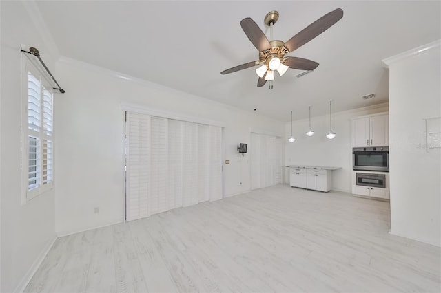 unfurnished living room with ornamental molding, light hardwood / wood-style floors, and ceiling fan