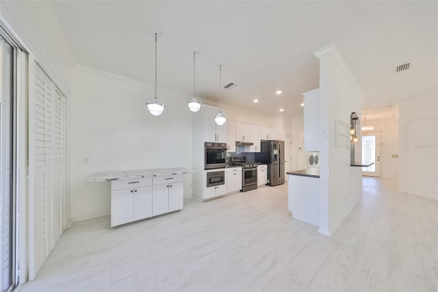 kitchen featuring white cabinets, hanging light fixtures, appliances with stainless steel finishes, and kitchen peninsula