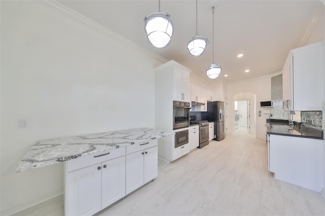 kitchen featuring backsplash, stainless steel appliances, crown molding, white cabinets, and pendant lighting