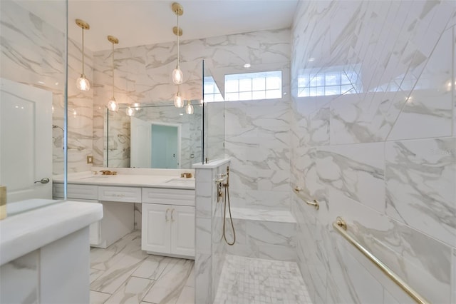 bathroom with tile walls, vanity with extensive cabinet space, a tile shower, and tile flooring