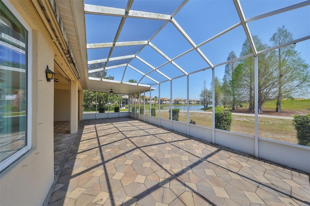 unfurnished sunroom featuring a water view