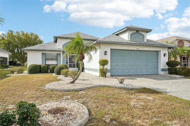 view of front of house featuring a garage and a front lawn