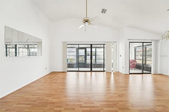 unfurnished room featuring high vaulted ceiling, light hardwood / wood-style flooring, and a healthy amount of sunlight