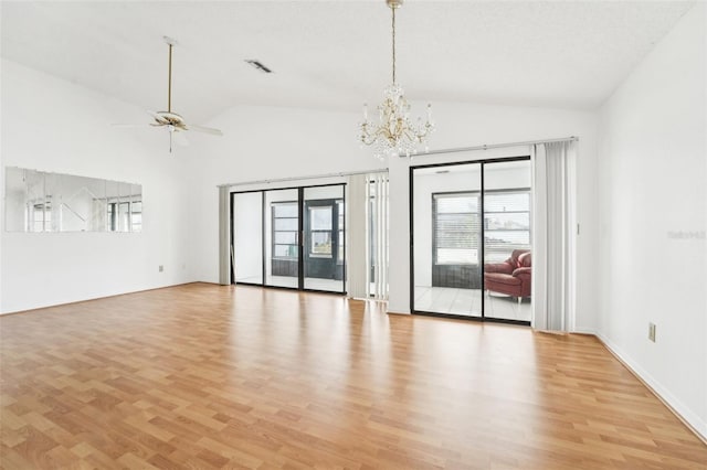 empty room with ceiling fan with notable chandelier, light wood-type flooring, and lofted ceiling