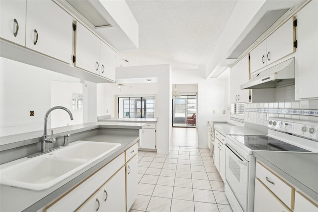 kitchen with decorative backsplash, white electric range oven, sink, white cabinetry, and light tile patterned flooring