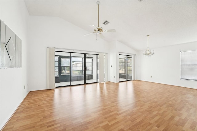 unfurnished room with plenty of natural light, light wood-type flooring, and ceiling fan with notable chandelier