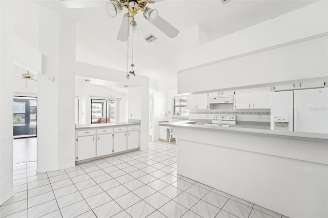 kitchen with white cabinetry, white refrigerator with ice dispenser, sink, and tasteful backsplash