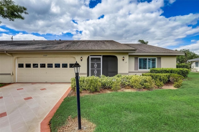 single story home featuring a front lawn and a garage