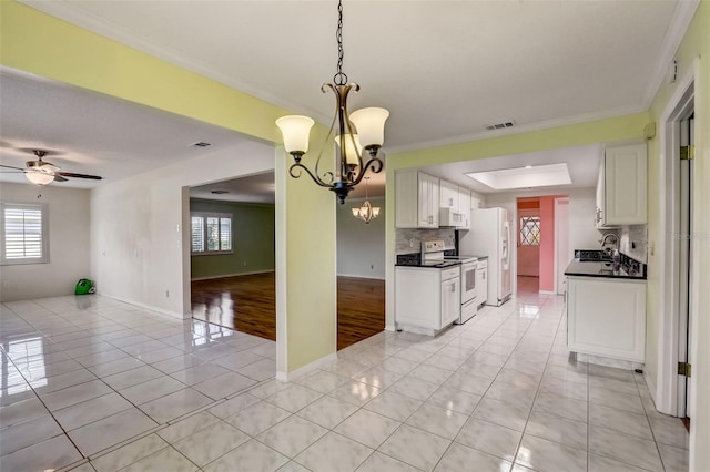 kitchen featuring white cabinets, decorative light fixtures, white appliances, and crown molding