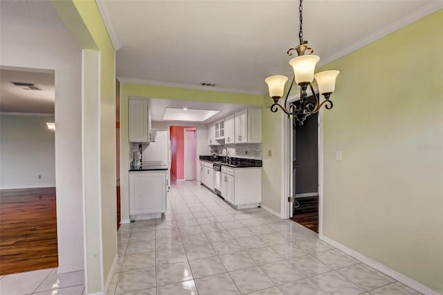 kitchen with a notable chandelier, ornamental molding, light hardwood / wood-style flooring, and white cabinetry