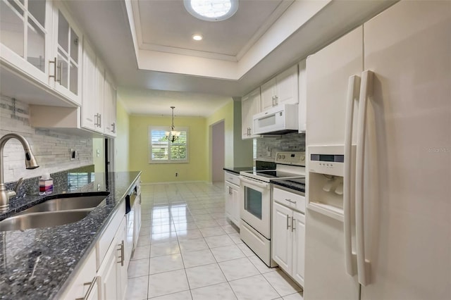 kitchen with a notable chandelier, white appliances, white cabinetry, backsplash, and sink