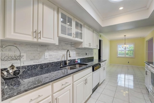 kitchen featuring a notable chandelier, white cabinets, and dark stone counters