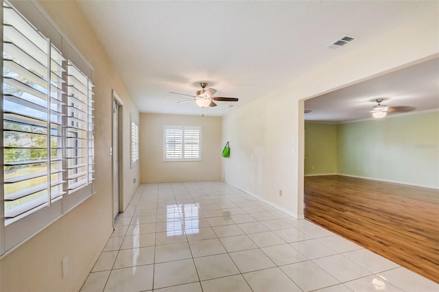 spare room featuring light hardwood / wood-style floors and ceiling fan