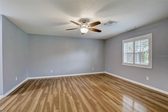 unfurnished room featuring hardwood / wood-style floors, a textured ceiling, and ceiling fan