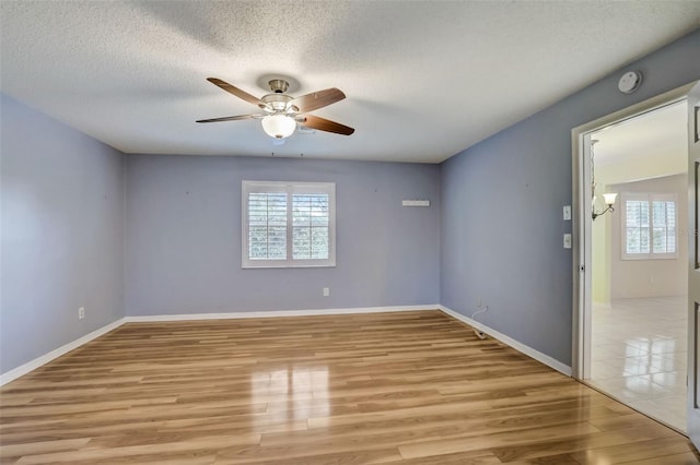 tiled spare room featuring ceiling fan and a textured ceiling